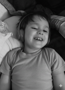 Young child experiencing sleep issues with autism, lying on a bed wearing headphones, smiling softly.